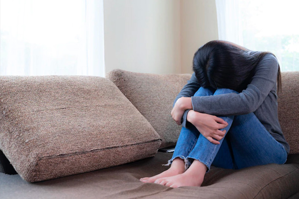 Depressed Woman Sitting on Couch